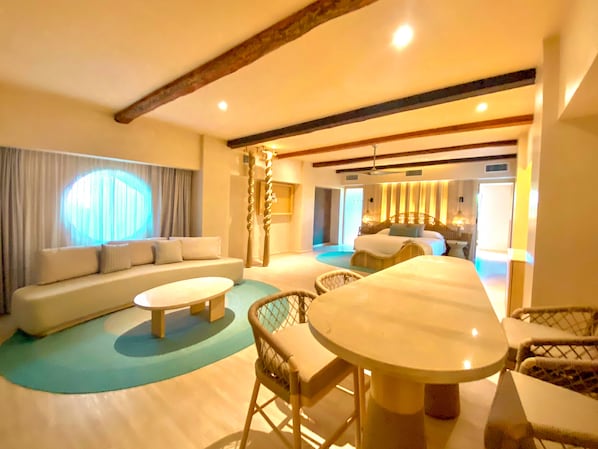 A spacious living area with a sofa set, a dining table, and a seating area with chairs. - Hotel Shibari Tulum (Tulum)