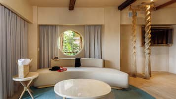 A modern living room with a sofa, a round coffee table, and a small side table.
