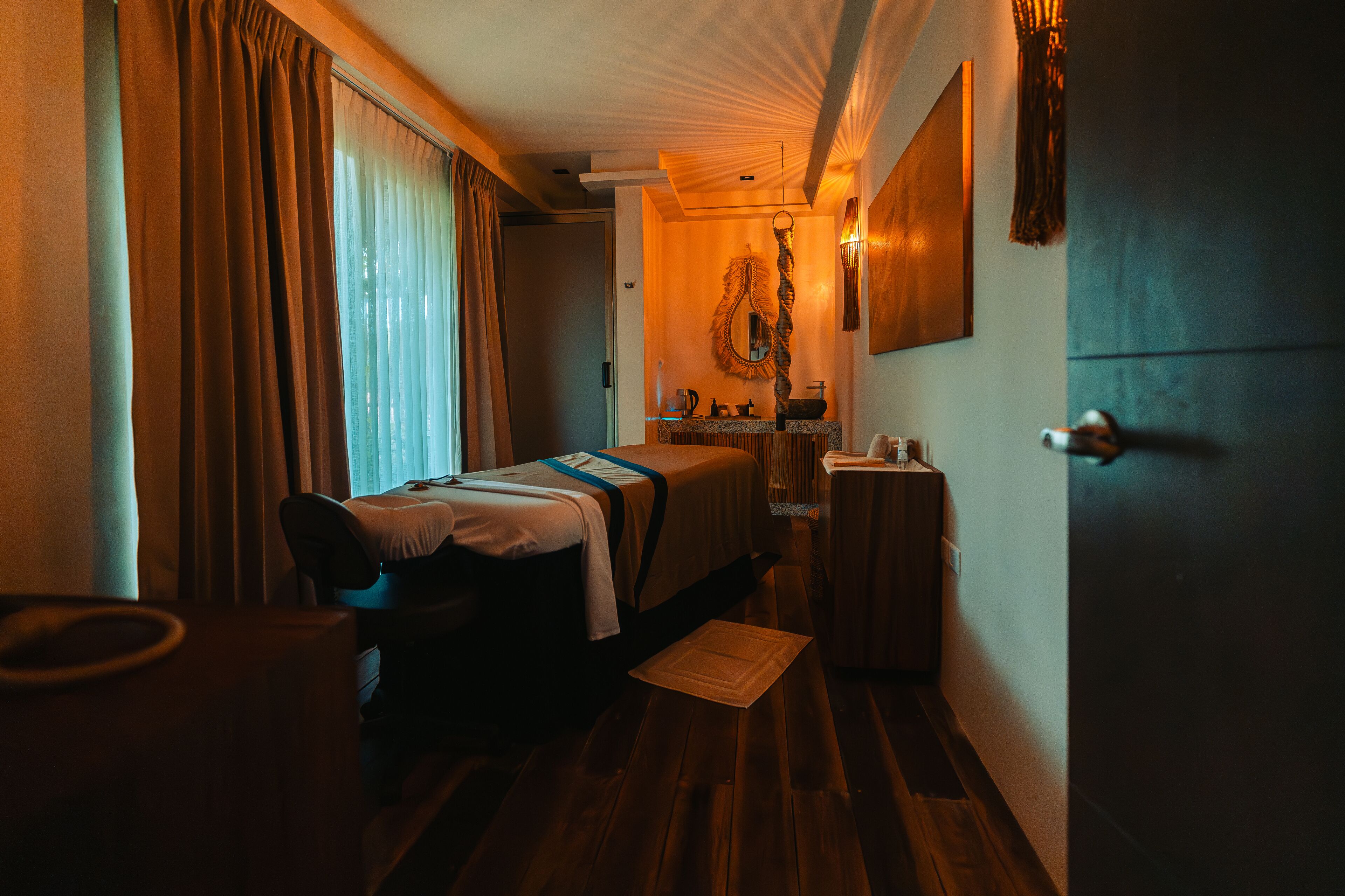Una habitación de hotel con cama, mesita de noche y espejo.