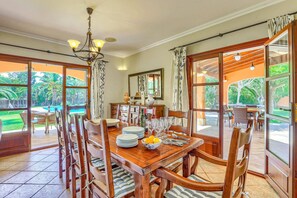 A dining area with a wooden table, chairs, and a chandelier. - Villa Marino by Villa Plus (Santañy)