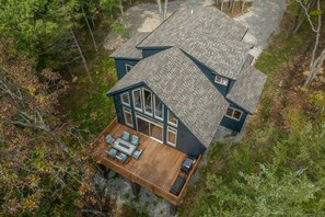 A two-story house with a large deck and a covered patio area. - Raynor Shine Chalet by Innsbrook Vacations! (Innsbrook)