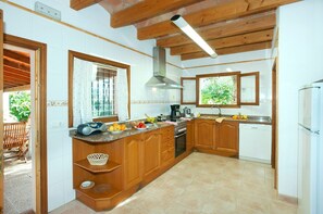 Kitchen features an oven, dishwasher, and range hood.