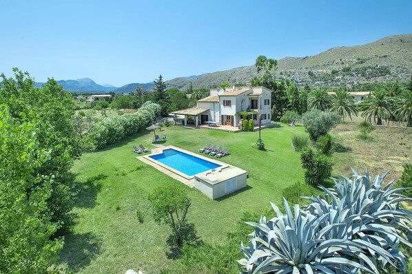 A house with a swimming pool, surrounded by lush greenery and a hilly landscape. - Villa Maina by Villa Plus (Mallorca)