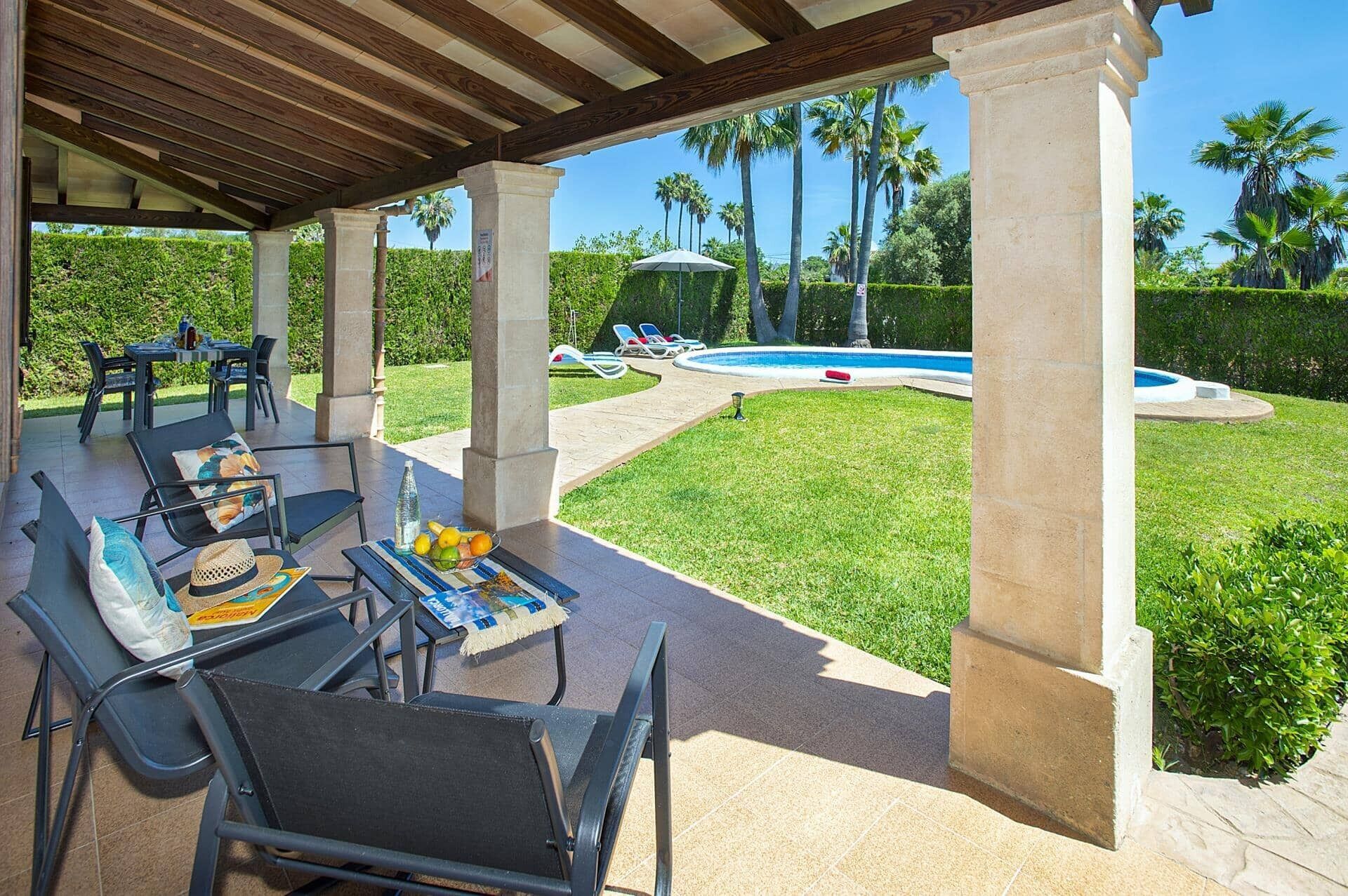 Eine Außenpatio mit Pool, Liegestühlen und einem Esstisch.