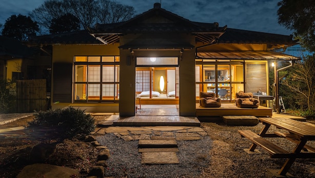 A traditional Japanese house with a wooden exterior, a stone pathway leading to the entrance, and a small outdoor seating area. - TEMPLESTAY ZENSO (Chiyoda Town, Oura District)