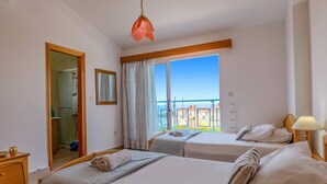 A hotel room with two beds, a bathroom, and a balcony with a view. - Villa Joanna Coral Bay by Villa Plus (Peyia)