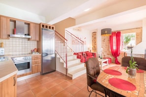 Enjoy meals in the kitchen and dining area, featuring a round table and potted plant.