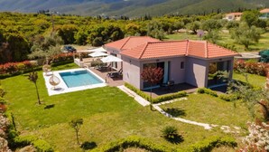 A house with a swimming pool, surrounded by lush greenery and mountains. - Villa Nectar by Villa Plus (Cephalonia)