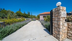 A stone gate with a sign reading 'villa Necrat.' - Villa Nectar by Villa Plus (Cephalonia)