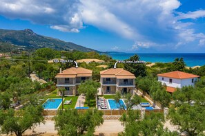 Two villas, Villa Ionio Elia and Villa Ionio Zafeiris, with swimming pools and a view of the sea.