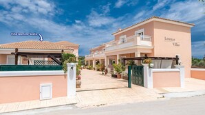 A villa named Jasmine Sostis and another named Lorenzo Villas, both with tiled roofs and a Mediterranean architectural style. - Villa Jasmine Sostis by Villa Plus (Agios Sostis)