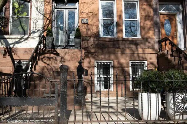 Traditional architecture meets modern charm in this two-story building with a central entrance and evenly spaced windows.