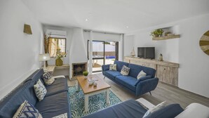 Una sala de estar moderna con un sofá, una mesa de centro y un televisor.