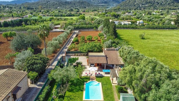 An aerial view of a property with a swimming pool, terraced gardens, and a view of the surrounding countryside. - Villa Joan Toni by Villa Plus (Pollença)