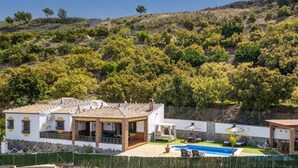 A villa with a swimming pool, outdoor seating, and a view of a hilly landscape. - Villa Maravillas by Villa Plus (Frigiliana)