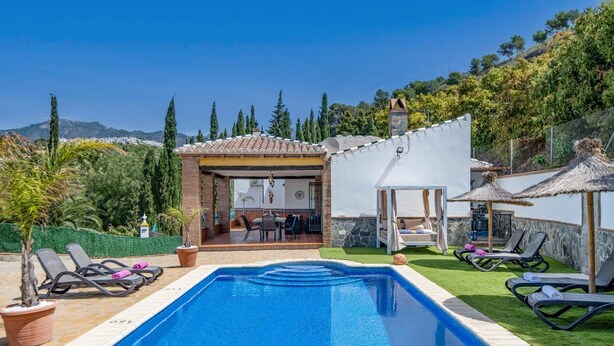A pool with lounge chairs, a covered patio, and a view of the surrounding landscape. - Villa Maravillas by Villa Plus (Frigiliana)