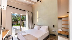 A modern bedroom with a large bed, a desk, and a view of the outdoors. - Villa Pasteli Sweet by Villa Plus (Kariotes)