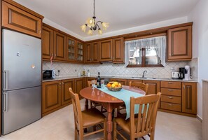 Enjoy meals at the round dining table with a view of the outside.