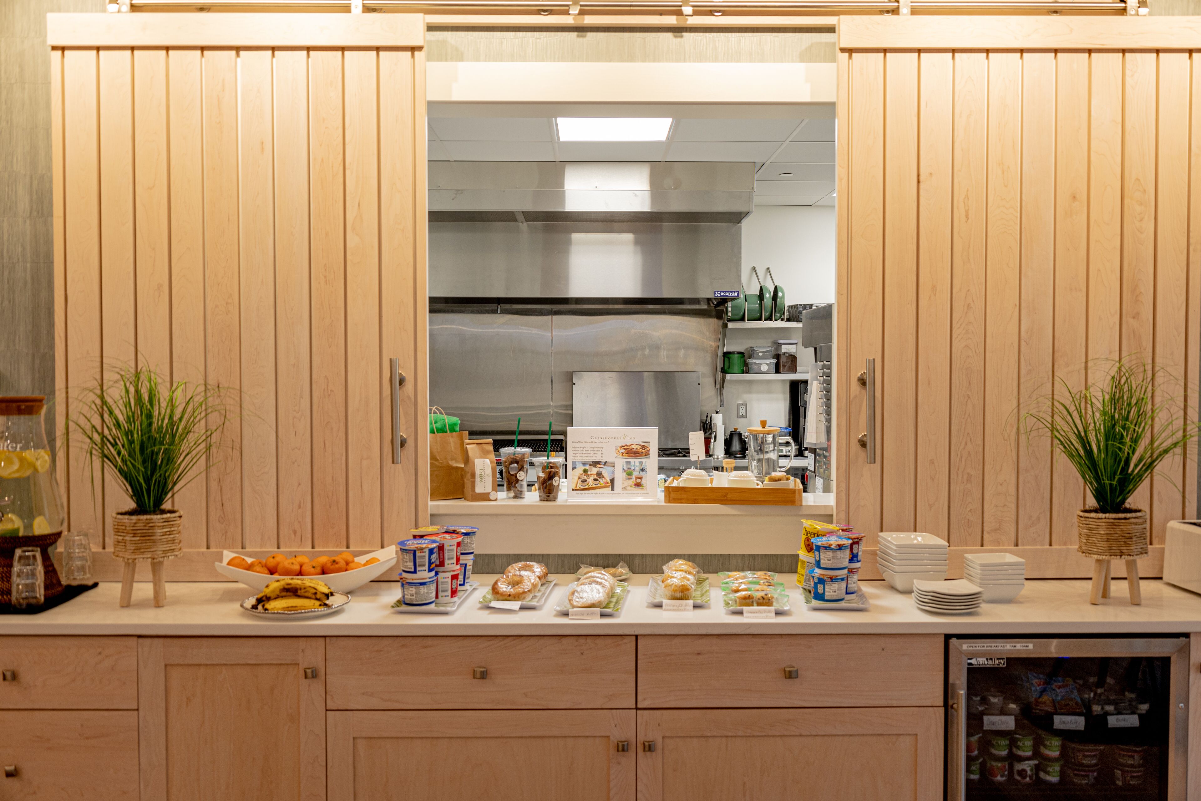 A kitchen counter with various food items and kitchen appliances.