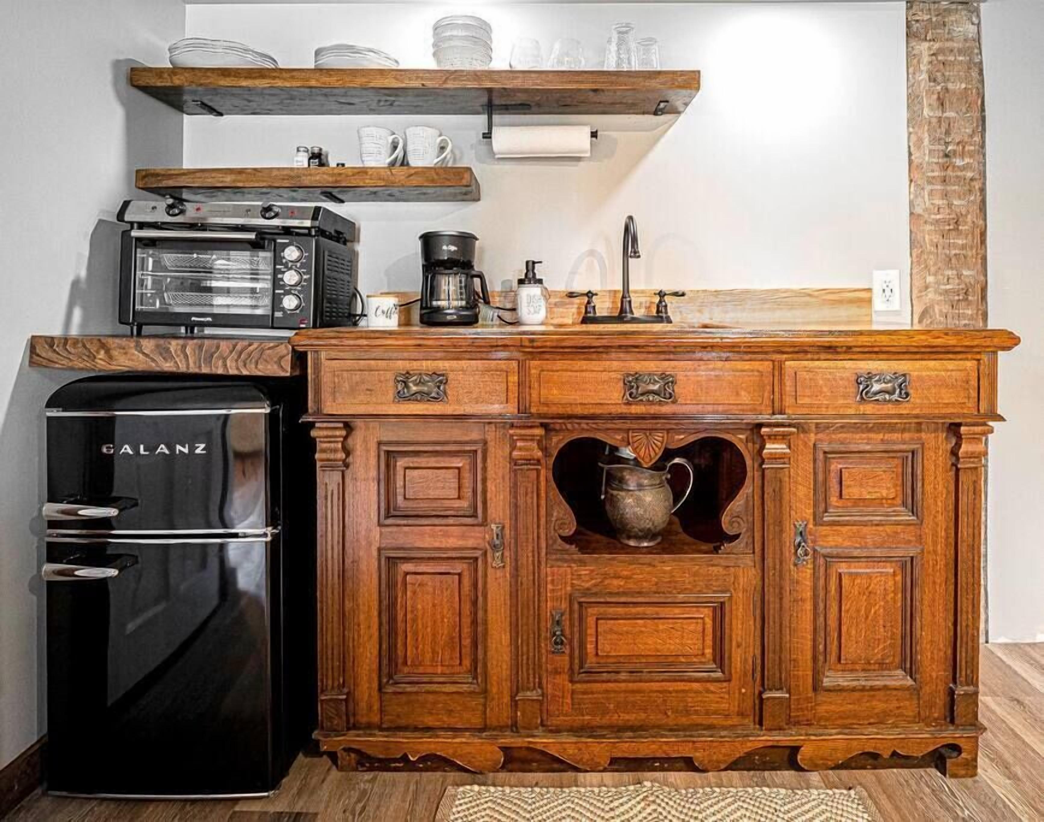A compact kitchen with a Galanz refrigerator, a coffee maker, and a toaster.