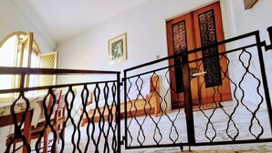 A staircase with a metal railing leading to a landing. - La Casa Di Edy (Prato)