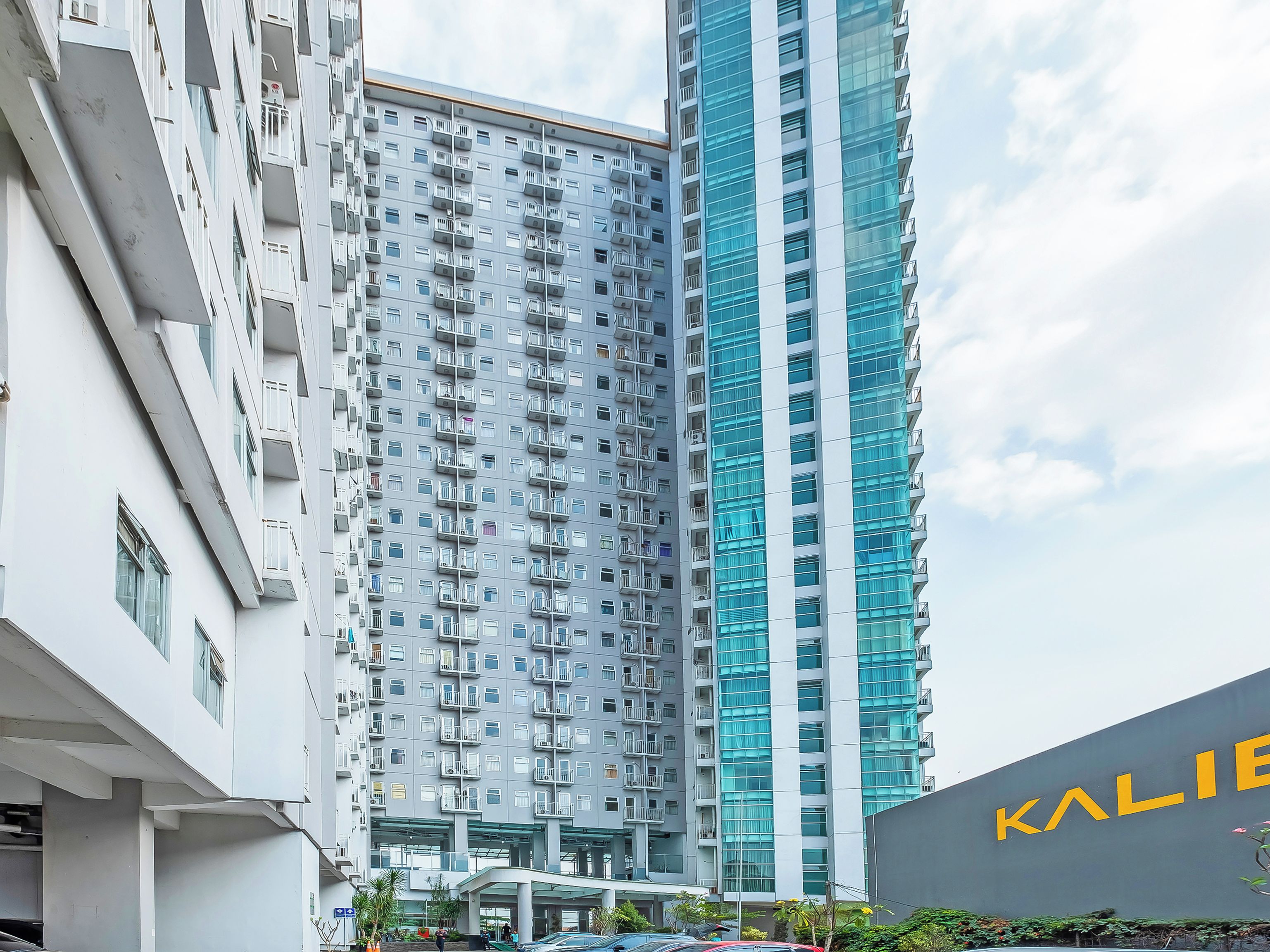 A high-rise building with multiple balconies and a modern architectural design.