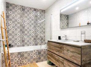 Bathtub, hair dryer, towels, soap
