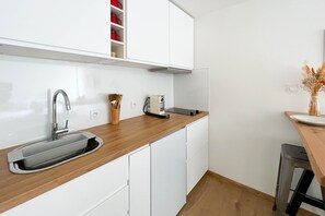 Fridge, microwave, coffee/tea maker, cookware/dishes/utensils