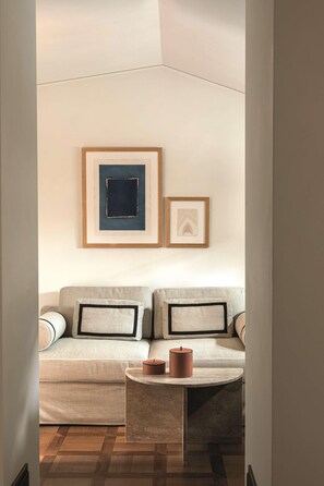 A modern living room with a sofa, a coffee table, and framed artwork on the wall. - Splendido Mare, A Belmond Hotel, Portofino (Santa Margherita Ligure)