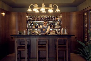 A bar area with wooden cabinets, a bartender, and a well-stocked shelf of bottles. - Splendido Mare, A Belmond Hotel, Portofino (Santa Margherita Ligure)