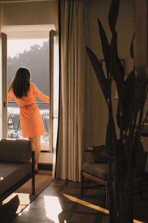 A woman in an orange dress standing by a window overlooking the sea. - Splendido Mare, A Belmond Hotel, Portofino (Santa Margherita Ligure)