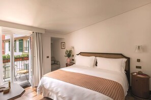 A hotel room with a bed, a bedside table, a nightstand, a chair, and a view of the outside balcony. - Splendido Mare, A Belmond Hotel, Portofino (Santa Margherita Ligure)