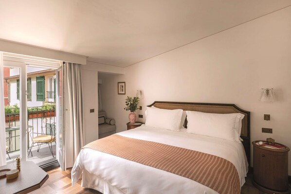 A hotel room with a bed, a bedside table, a nightstand, a chair, and a view of the outside balcony. - Splendido Mare, A Belmond Hotel, Portofino (Santa Margherita Ligure)