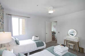 A hotel room with two beds, a vanity with a mirror, a lamp, and a view of the dining area. - ❤️ of DWNTWN, Riverfront w pool, walk 2 Broadway (Nashville)