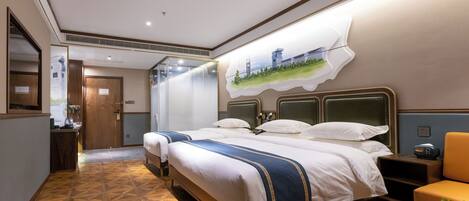 A hotel room with a large bed, a desk, a chair, and a small table with a plant.