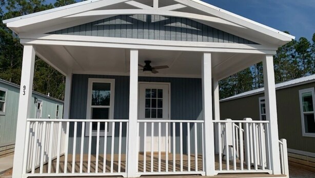 A single-story house with a covered porch, a central door, and a small window. - Short drive to the beautiful 30-A beaches!!
Cozy Riverwalk Landing Cottage 2-B (Freeport)