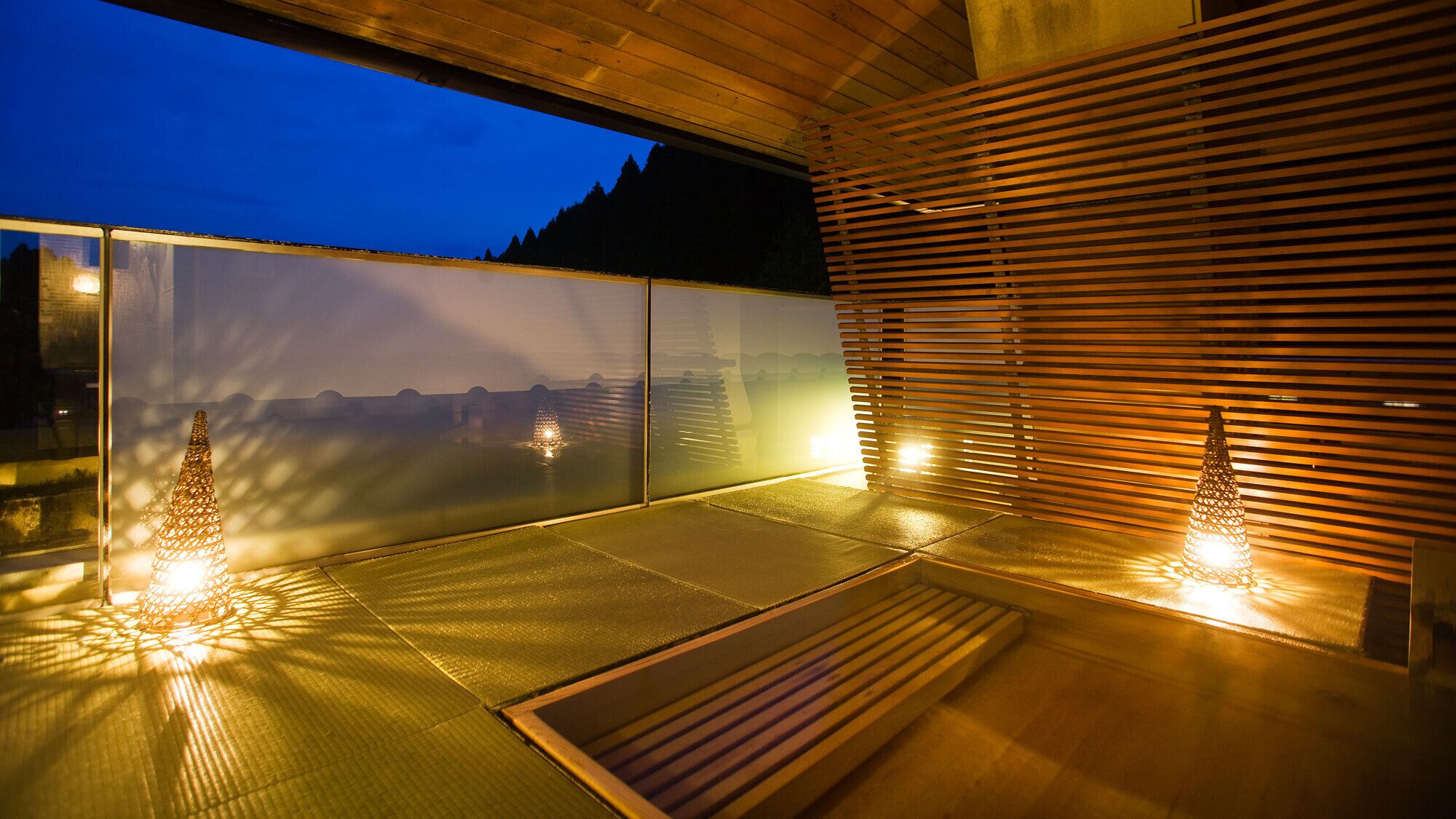 A modern interior with a view of a mountainous landscape through a large window.