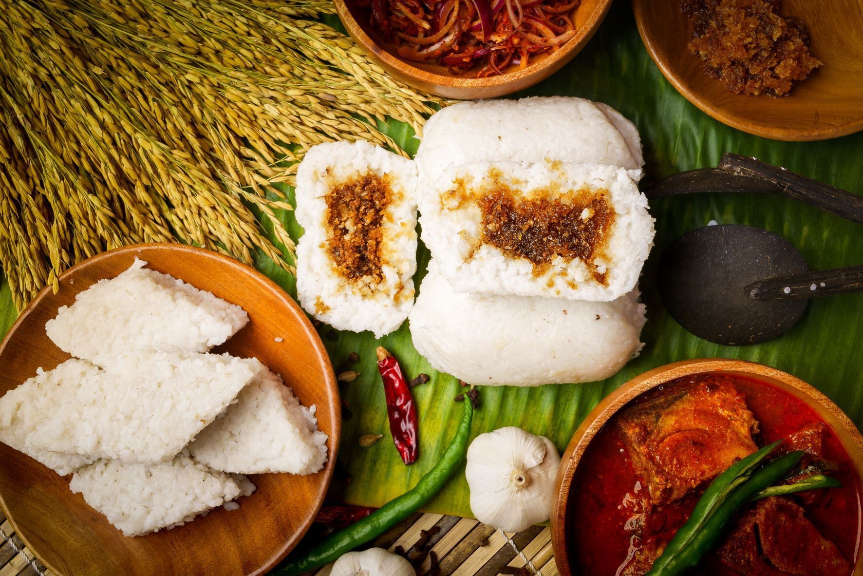 A traditional meal with rice, curry, and a bowl of spices.