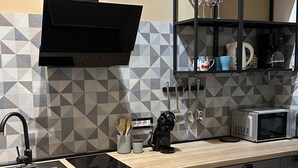 A modern kitchen with a built-in microwave, a coffee maker, and a wine rack.
