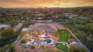 A residential area with a large house featuring a swimming pool, patio, and landscaped yard. - Desert Oasis ★Pool-Spa-Disc Golf-Ping Pong-Poker Table-Pool Table★ (Scottsdale)