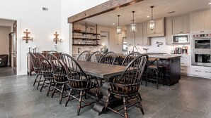 A spacious kitchen with a large island, modern appliances, and a dining area with wooden chairs. - Lone Star River Ranch- Large Luxury Venue for Conferences & Retreats - sleeps 44 (Brady)