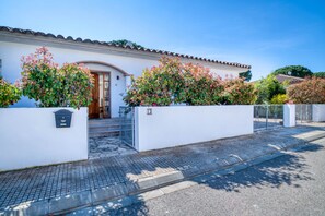 A white building with a tiled roof, a wooden door, and a mailbox. - LA BELLESA: Beautiful house with private pool in l'Escala (L'Escala)