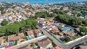 An aerial view of a residential area with houses, streets, and a large body of water in the background. - LA BELLESA: Beautiful house with private pool in l'Escala (L'Escala)