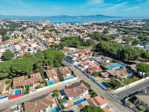 An aerial view of a residential area with houses, streets, and a large body of water in the background. - LA BELLESA: Beautiful house with private pool in l'Escala (L'Escala)