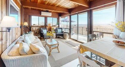 Water-view home with large deck, balcony, enclosed sunroom & peaceful location