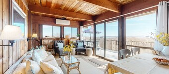 Water-view home with large deck, balcony, enclosed sunroom & peaceful location