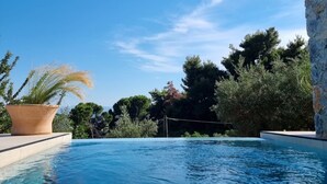 A clear blue pool with a stone pillar and a wooden roof structure. - Stone build Suite with private small pool (Skiathos)