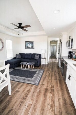 Relax in this inviting living space with a sofa, ottoman, and rocking chair.
