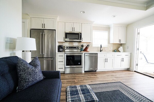 Enjoy cooking in this well-equipped kitchen with a refrigerator, microwave, oven, and dishwasher.