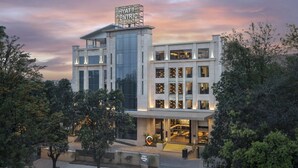 A modern hotel with a prominent sign, large windows, and a well-lit entrance. - Hyatt Centric Rajpur Road Dehradun (Dehradun)